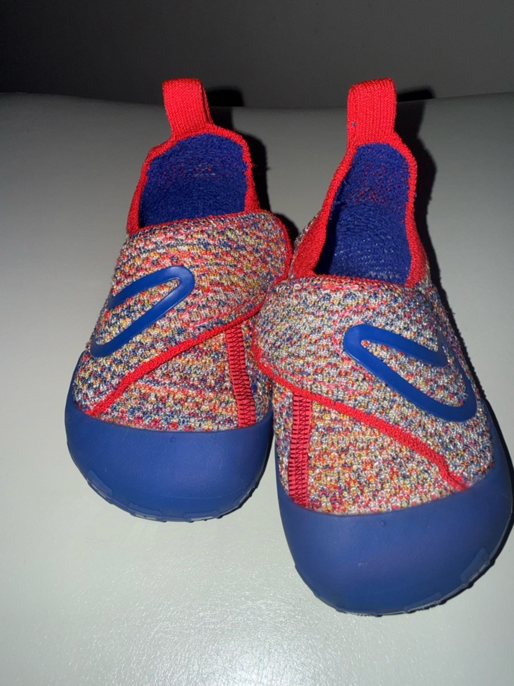 Nike toddlers Multicolor Slip-On Shoes with Blue and Red Accents